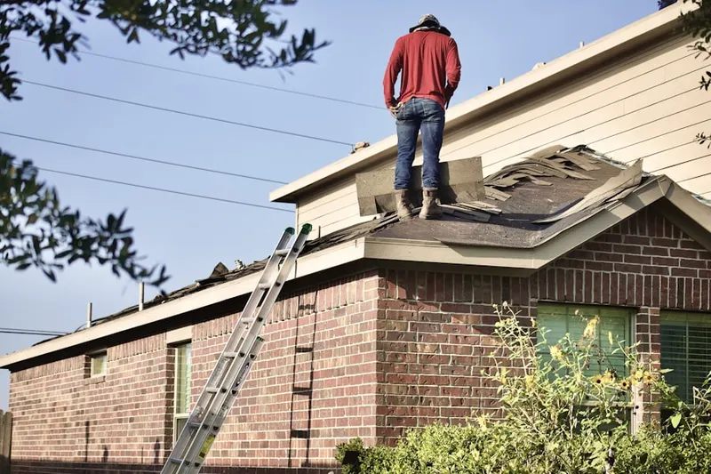 Professional roofer working on a residential roof in Wopowog